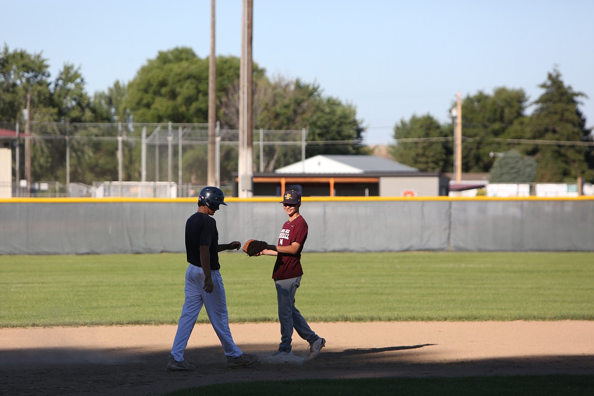 During a practice on July 14, two Riverdogs players shared a fist bump during a drill. The team is preparing for regional play.