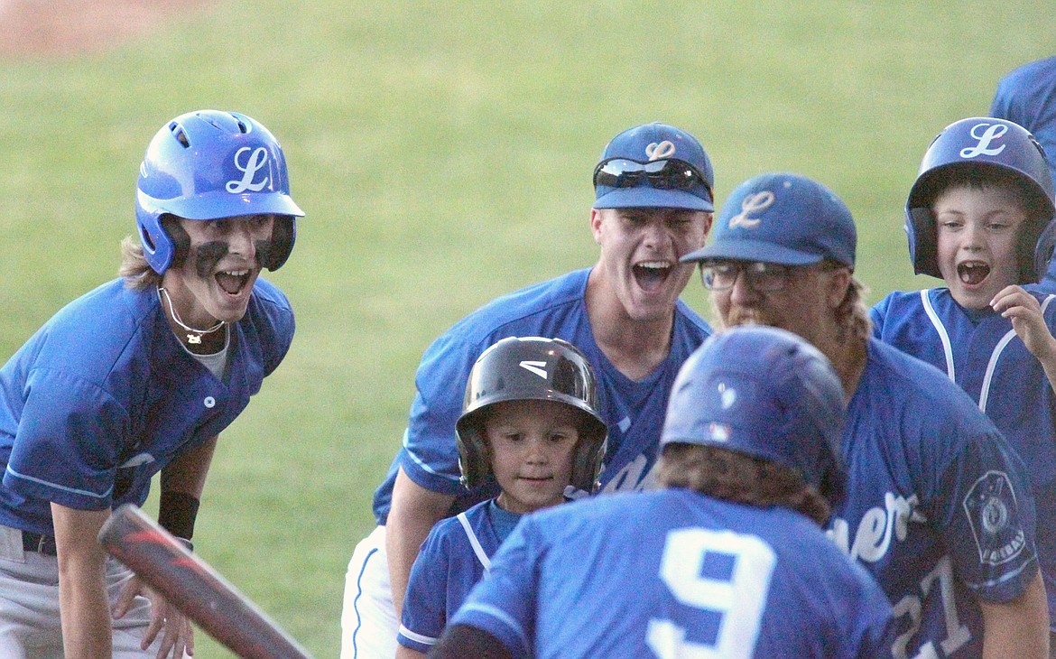 Libby Loggers Caden Williams, No. 9, is greeted by the dugout after smacking a 2-run homer bottom of the fifth inning Saturday evening. (Paul Sievers/The Western News)