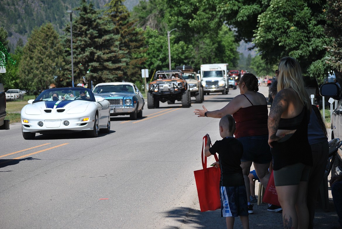 Families lined Railroad Avenue in Alberton Saturday morning as cars and floats passed by dispersing candy. (Mineral Independent/Amy Quinlivan)
