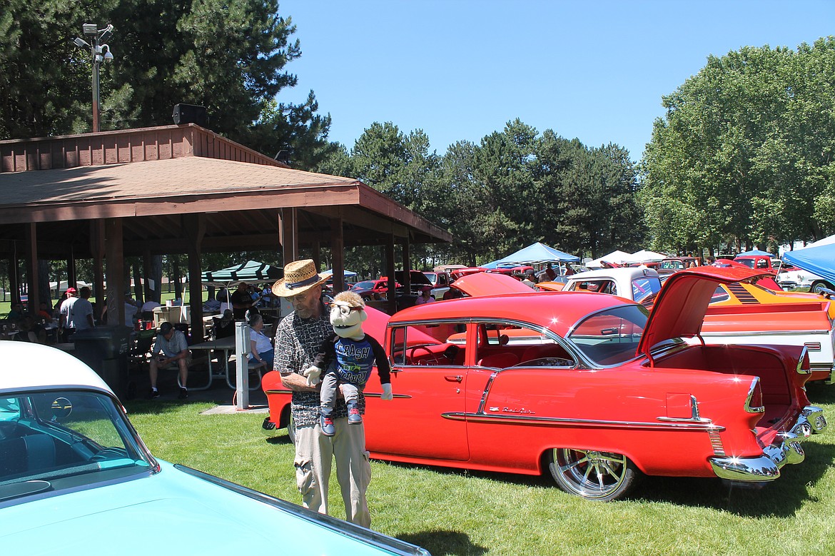 Simon, right, and his friend/transportation Cecil Aston of Selah look over the cars on display at the Othello All-City Classics car show Saturday.