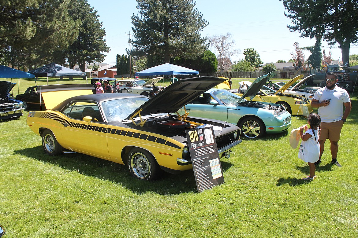 Three-year-old Darla Garcia and her dad Uriel Garcia check out a 1970 Barracuda at the Othello All-City Classics car show Saturday.