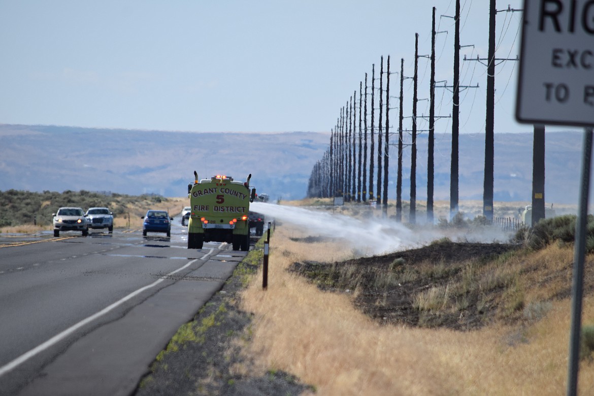 Crews with Grant County Fire District 5 douse a small blaze along the westbound side of SR17 Monday afternoon about midway between McConihe Road and Road 10 NE. A series of seven small fires broke out along SR17 between Ephrata and Moses Lake on Monday, likely the result of sparks from a vehicle dragging a chain, according to GCFD5 Battalion Commander Bob Horst.