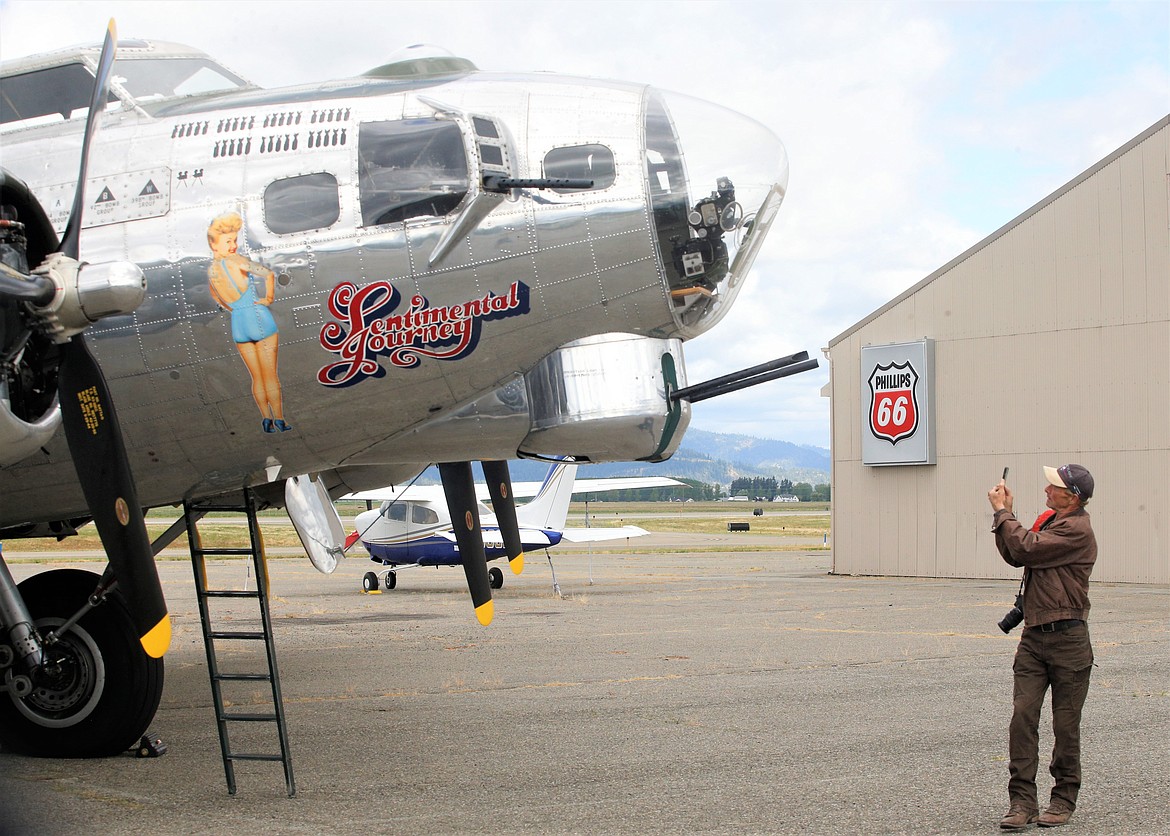 Michael Baker photographs the B-17, Sentimental Journey, at the Coeur d'Alene Airport on Monday.