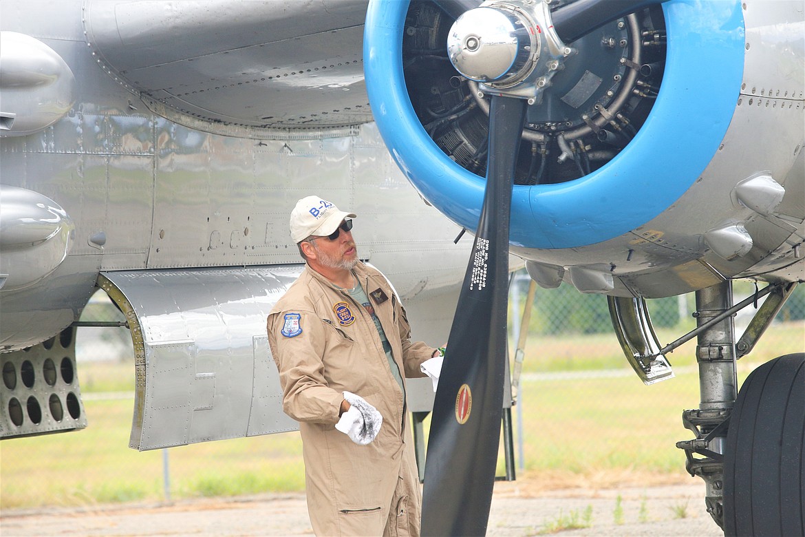 Crew Chief Bob Gates wipes down the B-25.