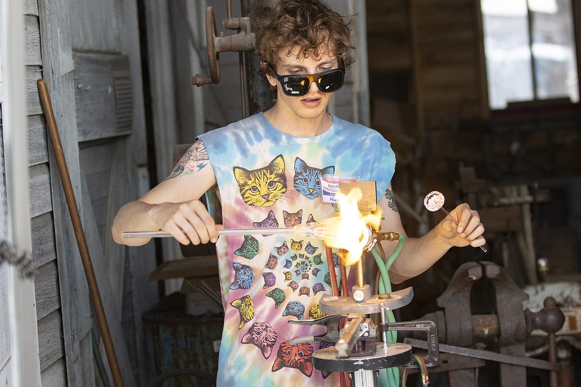 Hunter from Galaxy Glass demonstrates the fine art of glass blowing at Live History Days at the Miracle of America Museum in Polson. (Rob Zolman/Lake County Leader)
