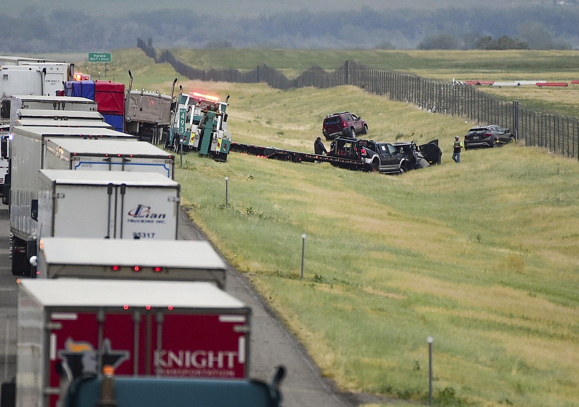 First responders work the scene on Interstate 90 after a fatal pileup where at least 20 vehicles crashed near Hardin, Mont., Friday, July 15, 2022. (Amy Lynn Nelson/The Billings Gazette via AP)