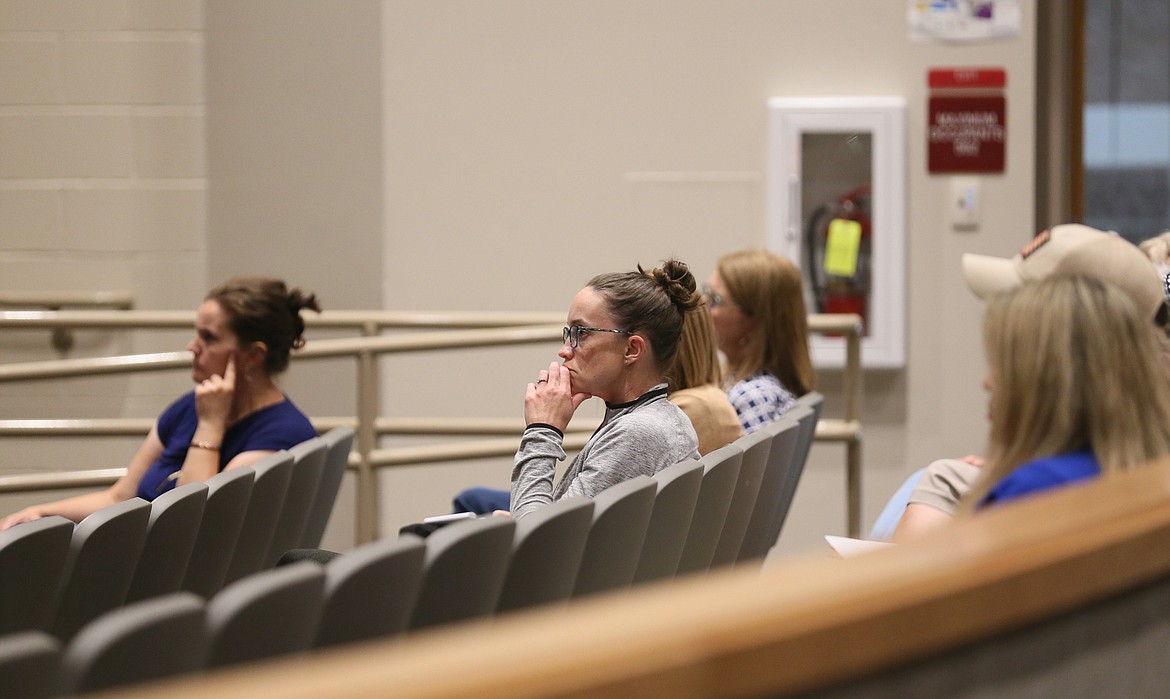 Concerned parents, family members and community members listen to a panel of school and safety leaders Monday evening.