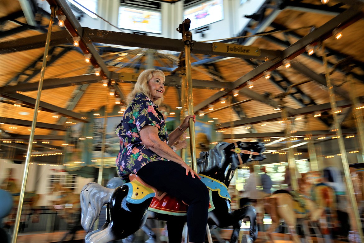 3Cs member Jeanine Puskas rides the Coeur d'Alene Carousel on Tuesday.