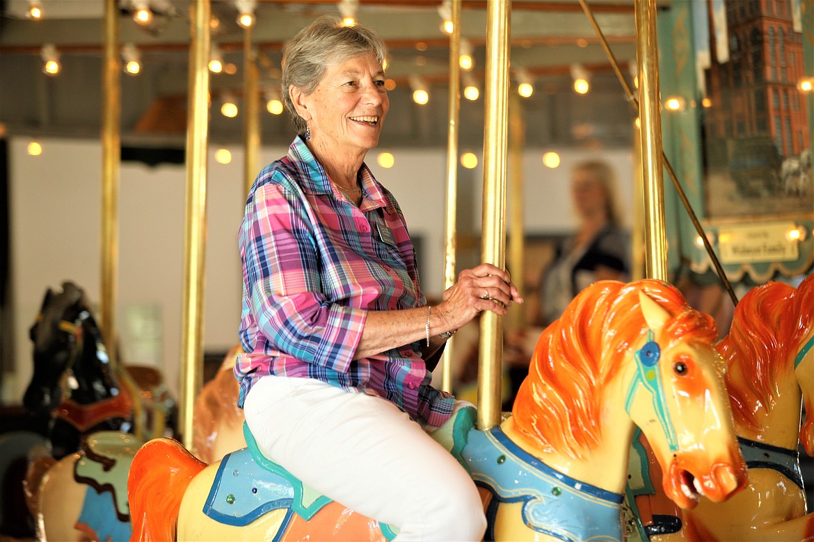 3Cs member Deanne Deady enjoys a ride at the Coeur d'Alene Carousel on Tuesday.