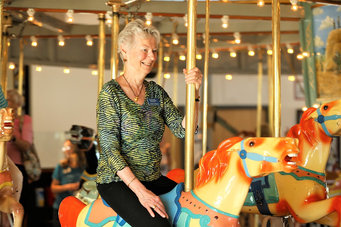 Linda Twiehaus smiles during a ride on the Coeur d'Alene Carousel on Tuesday.