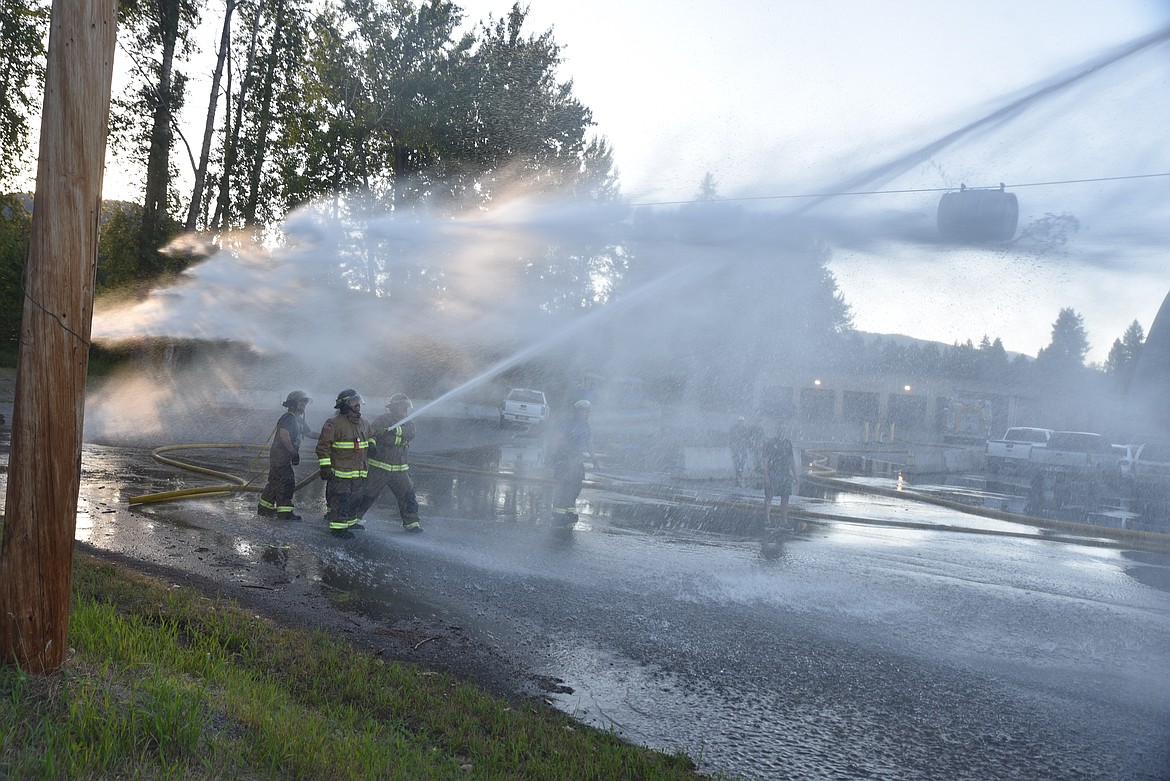 Libby Volunteer Fire Department members participated in a water fight at the high school on July 14. According to Second Assistant Chief Ryan Andreessen, the "fight" was part of training exercise where rookie firefighters get used to using a 2 1/2 inch line. (Scott Shindledecker/The Western News)