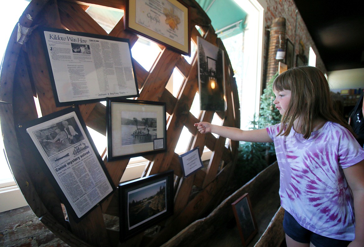 Ka-Mee-Lin camper Gray Conro examines pictures on display in the Post Falls Museum during a camp field trip Tuesday.
