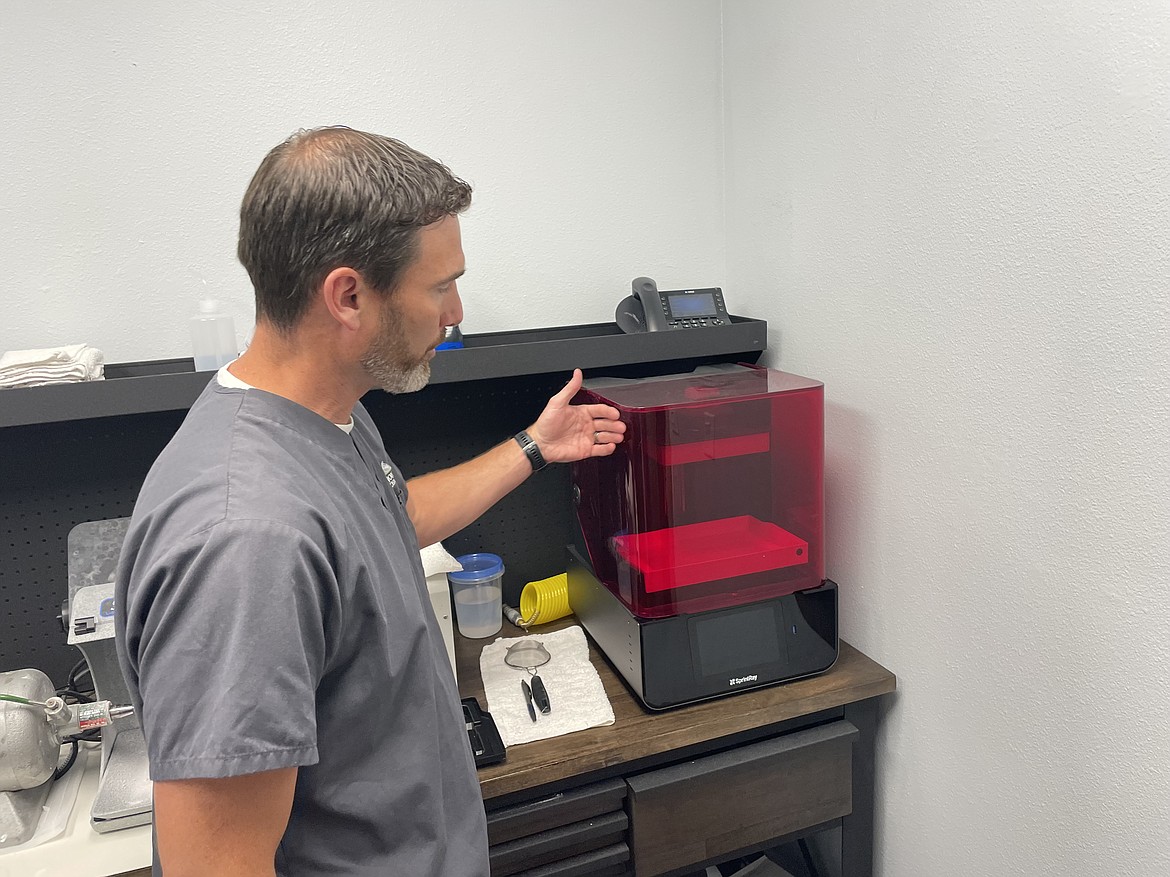 Dentist and denture maker Jon Dickson shows off the 3D printer he uses as part of Professional Dentures’ manufacturing process. The printer isn’t used to make final dentures, at least not yet, Dickson said, only to make test dentures to ensure they fit right.