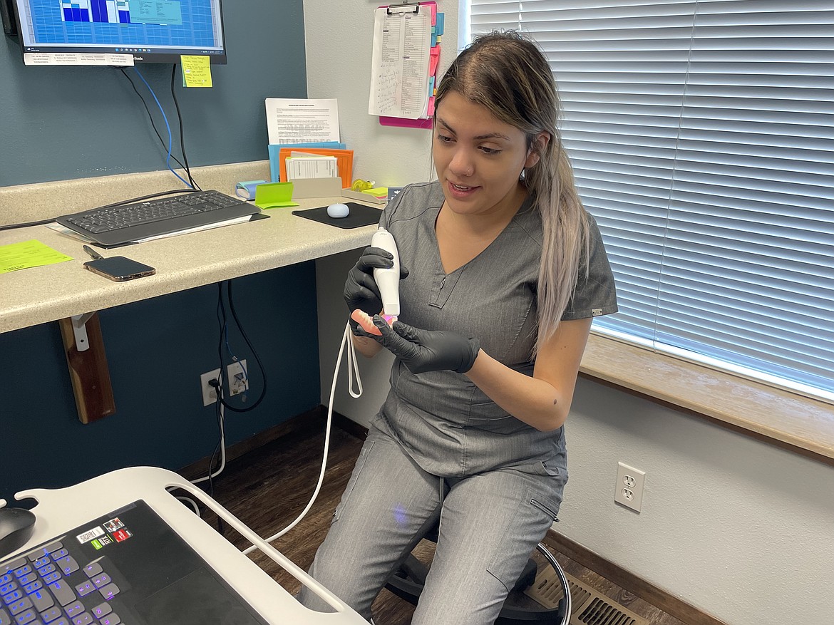 Professional Denture employee Jaylea Luna scans a denture.