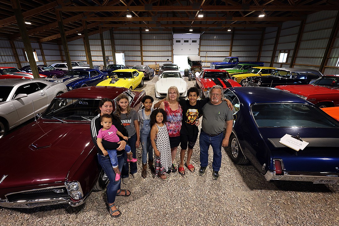 Donny Stevens, along with friends and family, stands among his muscle car collection in Columbia Falls. Pictured from left are Juanita Yeheyes and Gelila Yeheyes, Melody Smith, Elleni Yeheyes, Lydia Yeheyes, Lori Botkin, Hayzen Yeheyes and Donny Stevens. (Jeremy Weber/Daily Inter Lake)