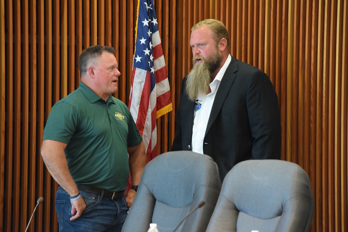 Grant County Sheriff candidates Joe Kriete and James Baker talk with each other following the candidate forum on Tuesday at the Moses Lake City Council chambers.