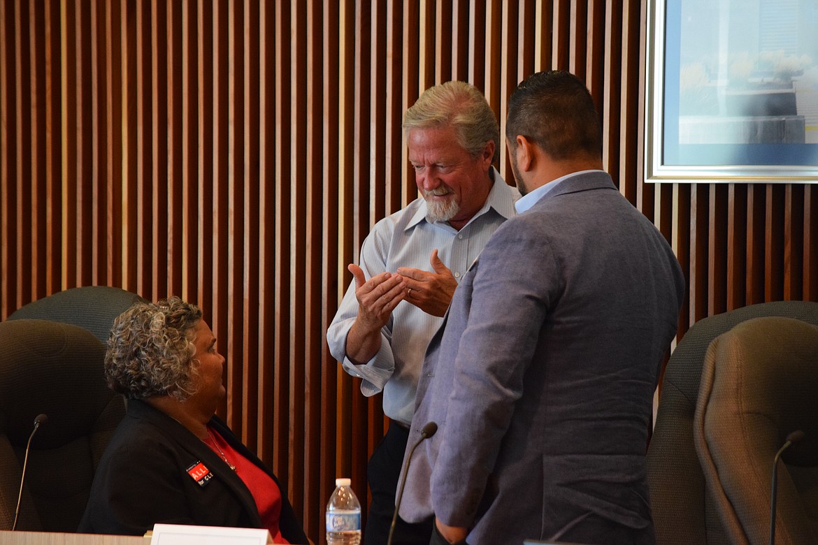 Grant County Clerk Kimberly Allen, commission candidate Jeff Foster, and clerk candidate Ulises Infante speak during a break at the candidate forum on Tuesday.