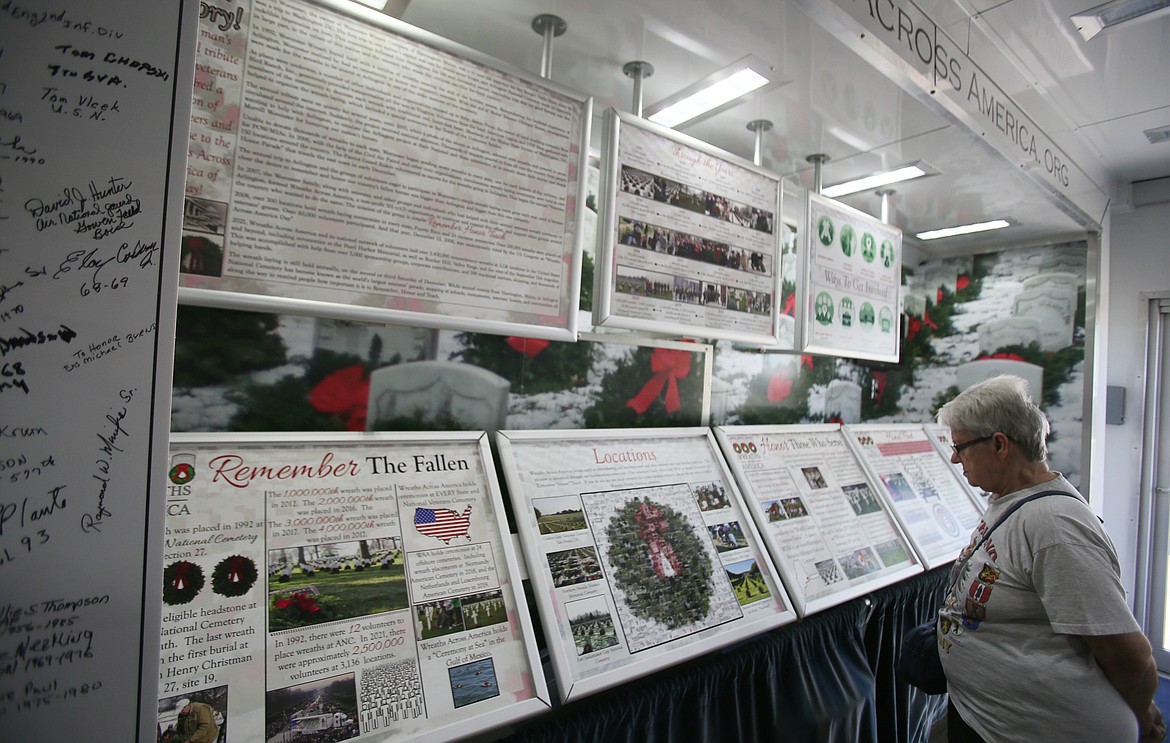 Janet Olson views the displays in the Wreaths Across America Mobile Education Exhibit on Wednesday morning.