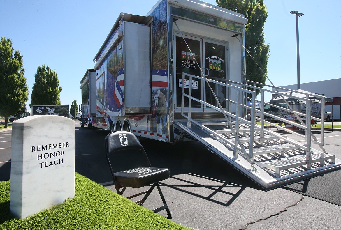 A POW/MIA chair, which represents the service members unable to fill it because of their sacrifices, and headstone with "remember, honor, teach" can be seen outside the 48-foot mobile Wreaths Across America exhibit Wednedsay.