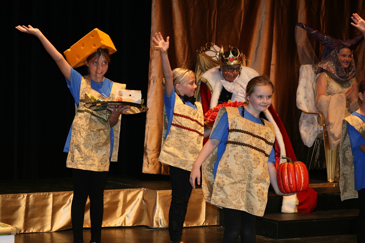 The menu for the grand ball is presented to the unenthusiastic king (LJ Beavers, background) in the Basin Community Theatre production of “Cinderella.”