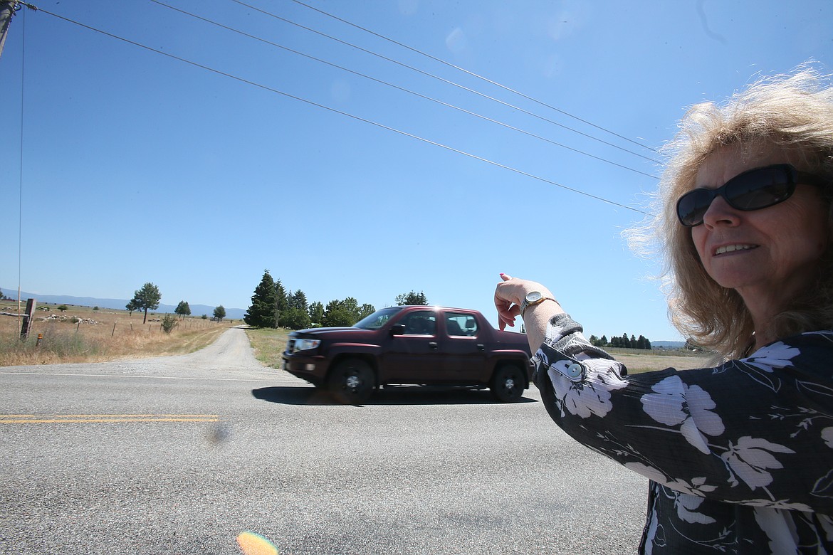 Longtime Post Falls resident Kaye Balk points to a dirt road across the street from her house, indicating the north perimeter of property where a 41-acre annexation is being requested at Greensferry Road and Prairie Avenue.