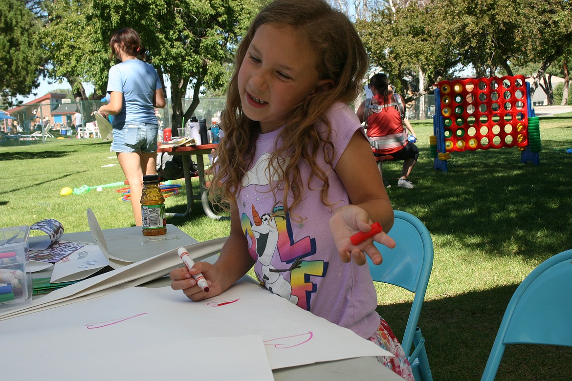 Y’know, Adyson Taylor is just working on decorating her giant paper airplane Wednesday afternoon. Paper airplanes are one of the activities in the repertoire of the mobile rec van.