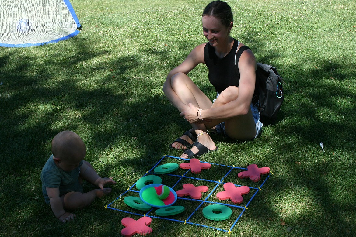 Zion Khomyak (left) and his mom Sofiya Khomyak (right) play the tic-tac-toe game from the mobile rec van.