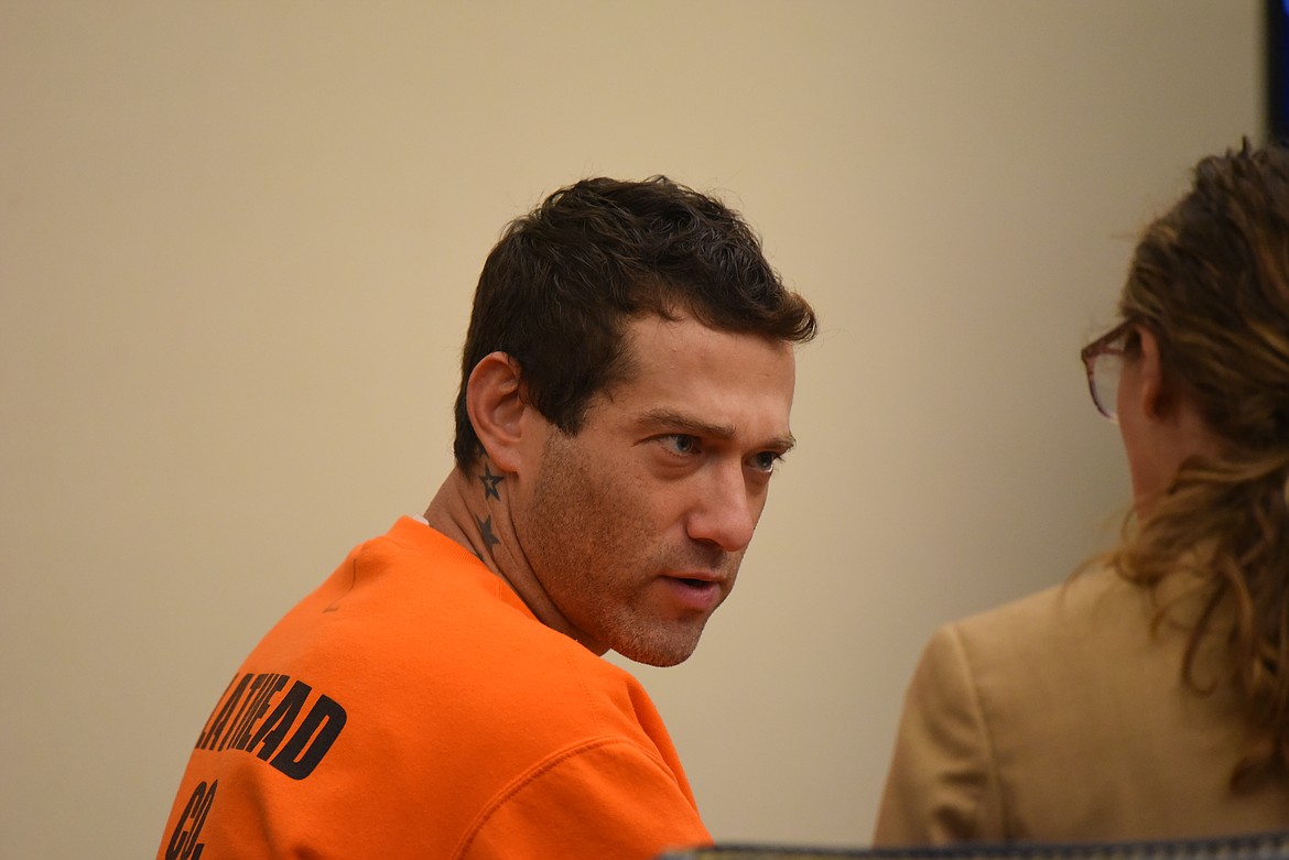 Robert McCarty speaks with his attorney during his arraignment in Flathead County District Court on July 21, 2022. (Derrick Perkins/Daily Inter Lake)