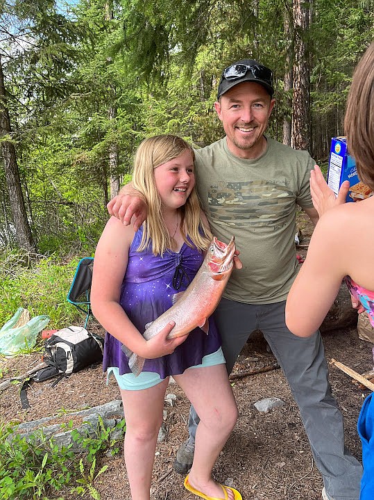 Libby Schools teacher Bill Moe and Madison show off the big cutthroat trout she caught during the Kootenai Outdoors Adventure Program.