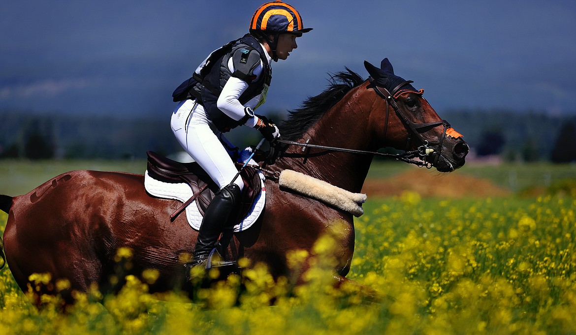 Elisabeth Halliday-Sharp rides through the canola during The Event at Rebecca Farm July 23. (Jeremy Weber/Daily Inter Lake)