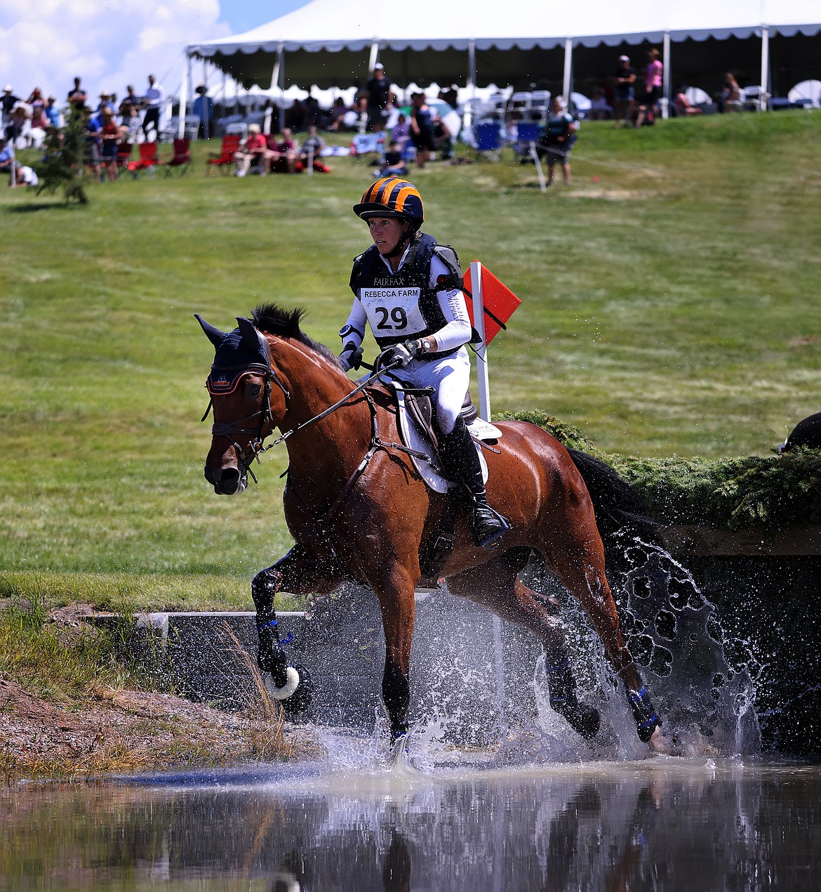 Elisabeth Halliday-Sharp rides "Cooley Nutracker" through the second water feature of the three-star long course at The Event at Rebecca Farm July 23. (Jeremy Weber/Daily Inter Lake)