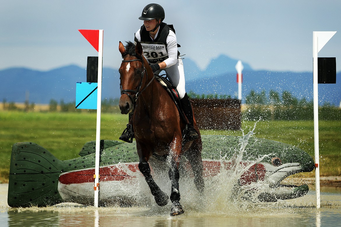 Ella Marquis rides her horse "Big Pretty" through the first water feature of the Training division of The Event at Rebecca Farm July 22. (Jeremy Weber/Daily Inter Lake)
