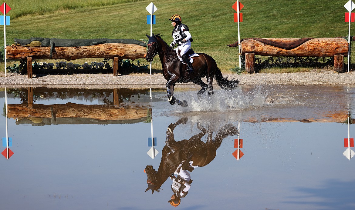 Elisabeth Halliday-Sharp rides "Cooley Nutracker" through the first water feature of the three-star long course at The Event at Rebecca Farm July 23. (Jeremy Weber/Daily Inter Lake)