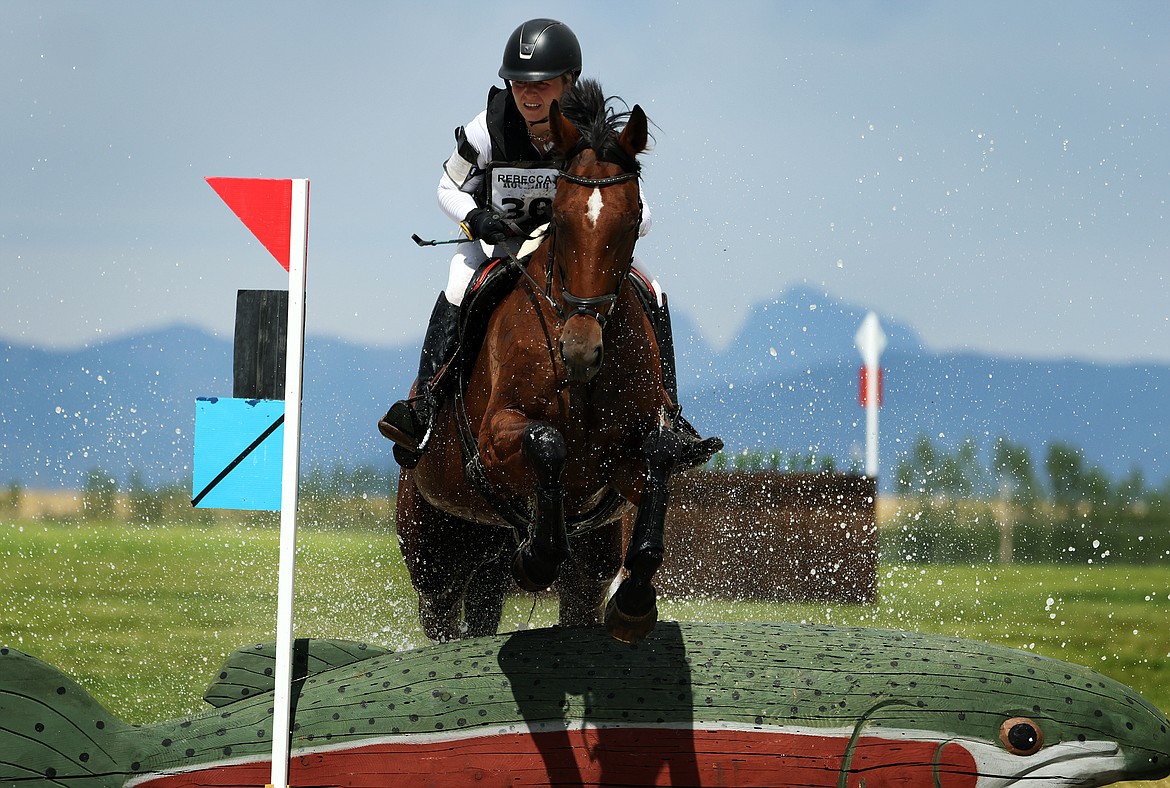 Ella Marquis rides her horse "Big Pretty" through the first water feature of the Training division of The Event at Rebecca Farm July 22. (Jeremy Weber/Daily Inter Lake)