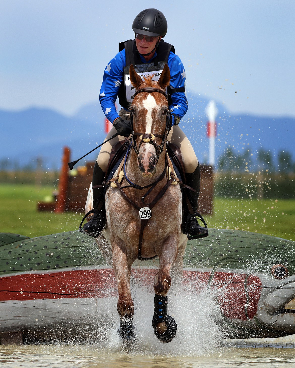 Craig Heckert rides "RF Arkenstone" through the first water feature of the Training division of The Event at Rebecca Farm July 22. (Jeremy Weber/Daily Inter Lake)