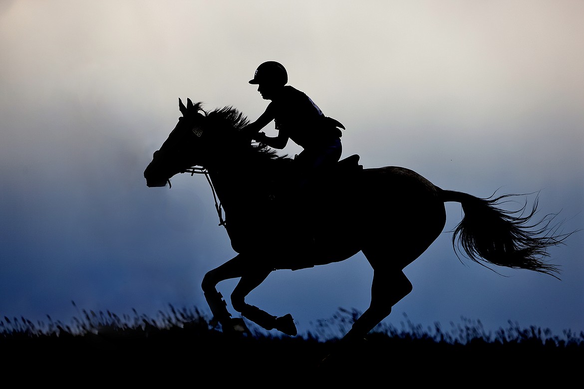 Lydia Summer and her horse "Gio Star" are silhouetted against the rainy sky during the Training division of The Event at Rebecca Farm July 22. (Jeremy Weber/Daily Inter Lake)