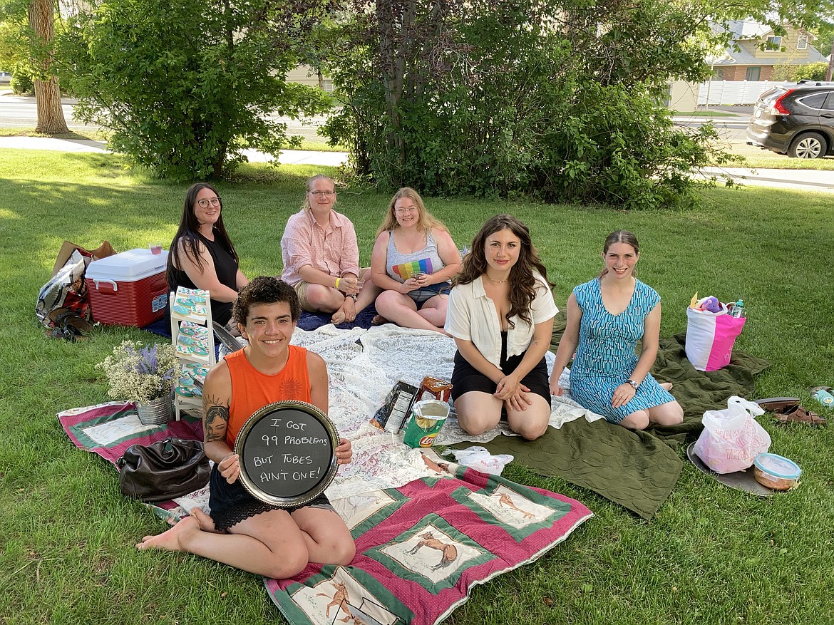 Dani Marietti (holding sign) and her friends gather for a “sterilization shower” in Helena, Montana, in July before Marietti was scheduled to have her fallopian tubes surgically removed. (ELLIS JUHLIN / YELLOWSTONE PUBLIC RADIO)