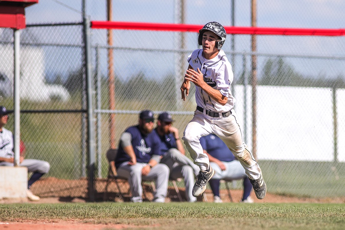 Kellen Kroger heads for home to score a run for the Twins on Friday of the West A District Legion baseball tournament in Kalispell. (JP Edge photo)
