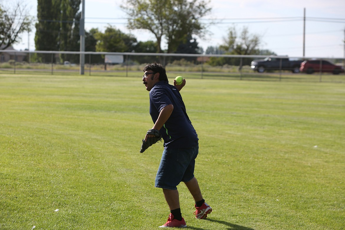 A Moses Lake outfielder throws a hit ball back into the infield during the scrimmage.