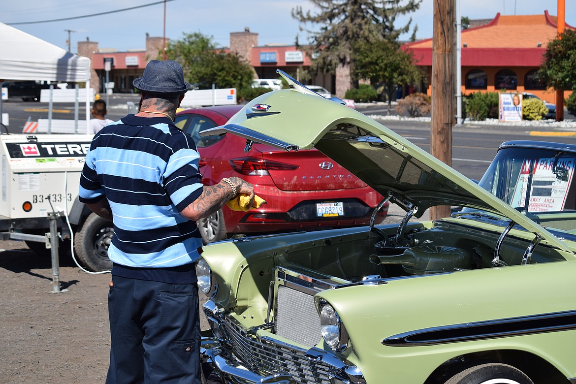 Dillon Arcega finished wiping off some of the chrome on his customized 1956 Chevrolet Bel Air lowrider.