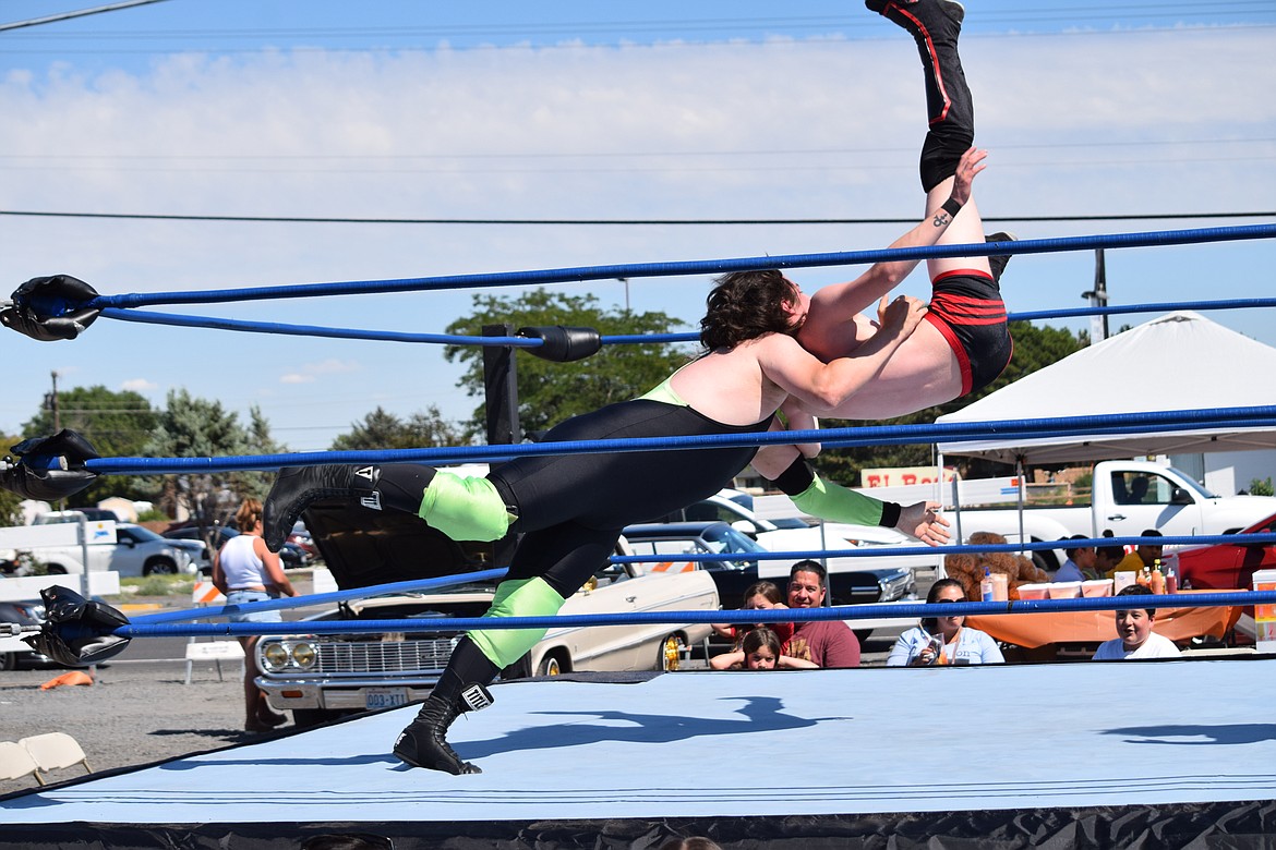 Wrestler J.D. Mason, trainer and owner of North West Pro Wrestling, throws Christian Wide during their bout at the EDUBB C/S grand opening on Saturday.