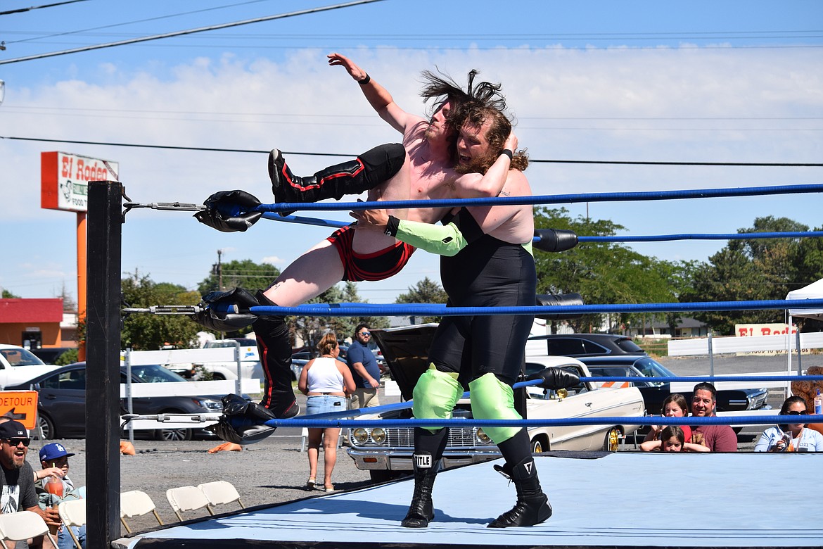 J.D. Mason pushes Christian Wide up against the corner of the ring during a Lucha Libre match on Saturday.