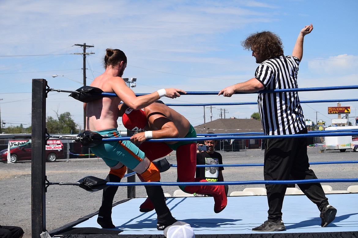 Lucha Libre wrestler A.J. Melon delivers a knee to the groin of his opponent Some Dude Chillin while referee Garrett Ambrose looks on during a wrestling match on Saturday.