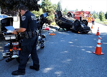 A Coeur d'Alene police officer investigates a two-vehicle injury-accident on Northwest Boulevard between Hubbard and River avenues about 2:30 p.m. Tuesday. At least one person was taken to Kootenai Health. An investigation continues.