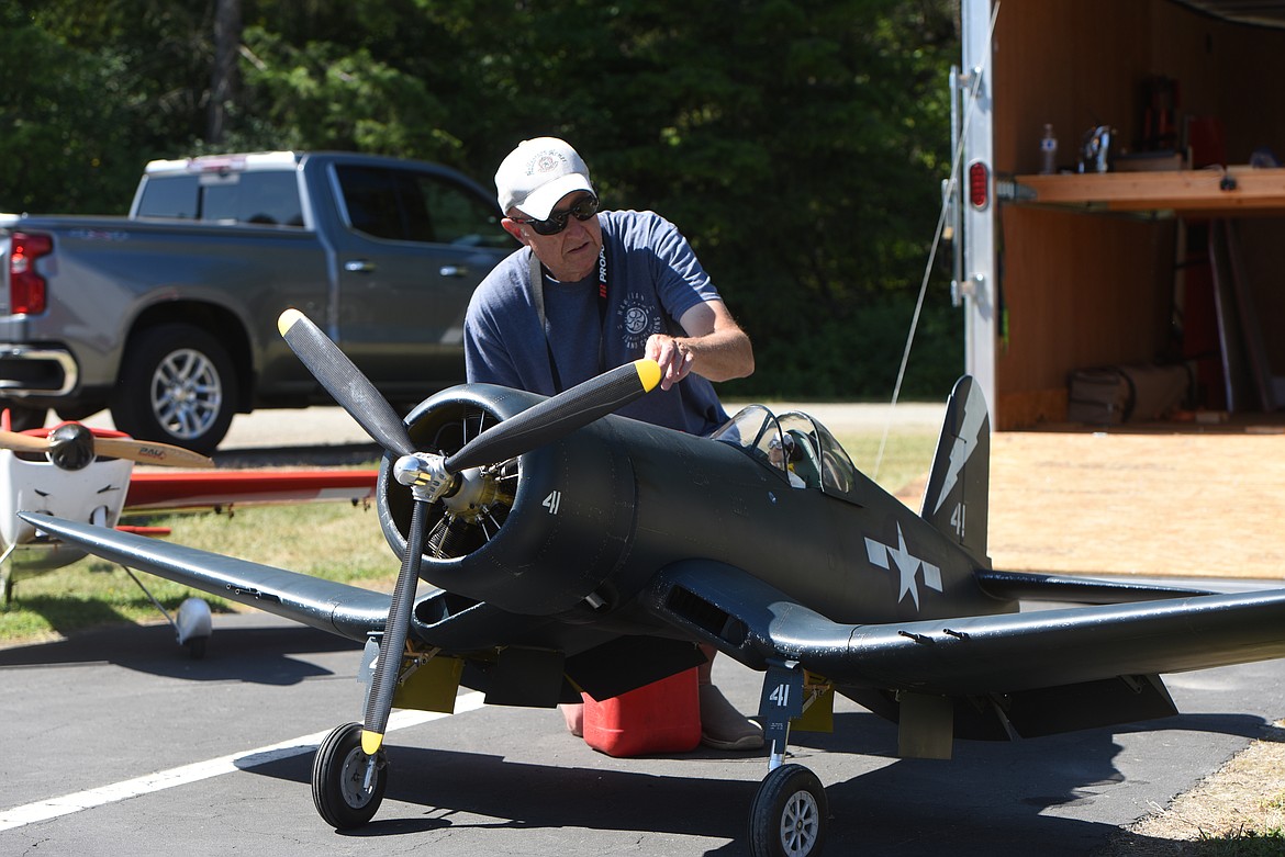 Ken Huber of Kalispell prepares to start his Corsair Saturday, July 23, 2022, at the Kootenai RC Flying Field. Huber didn't fly the plane, but started it so people could hear the roar of the engine. (Scott Shindledecker/The Western News)