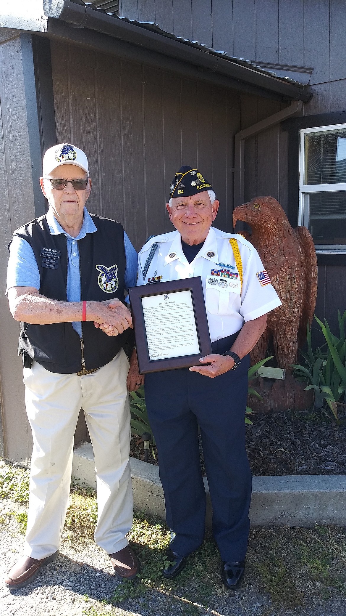 During the ceremony, Len Crosby was honored with an Honorary Life Membership to the Post Falls Eagles No. 3682. Following lengthy research, a resolution for that event was sent to the Fraternal Order of Eagles in Garden City, Ohio, for their affirmative action, which they passed. Past President of the Post Falls Eagles No. 3682 Dustin Okon, left, presents the resolution to Crosby.