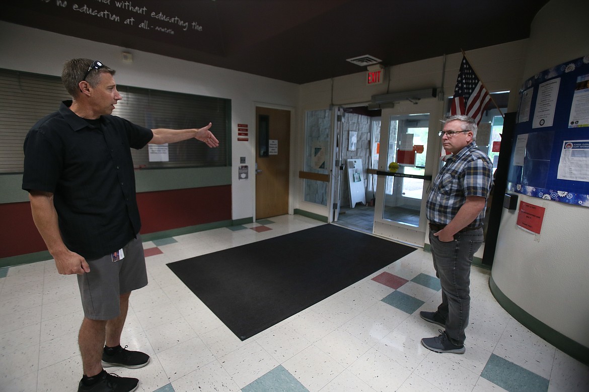 Coeur d'Alene School District Director of Operations Jeff Voeller, left, and district spokesman Scott Maben discuss the need to tighten security at the Fernan STEM Academy entrance. The district is asking the community to vote on a safety and maintenance levy Aug. 30.