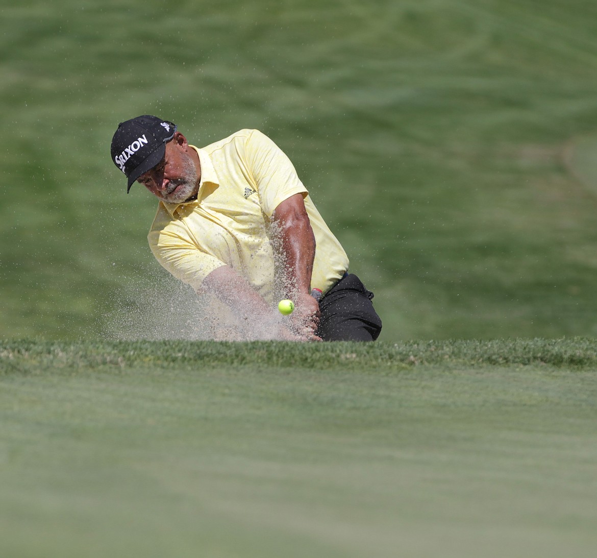 JASON ELLIOTT/Press
Former NHL goaltender Grant Fuhr hits out of the sand at the 18th hole of the Showcase golf exhibition at The Coeur d'Alene Resort Golf Course on Saturday.