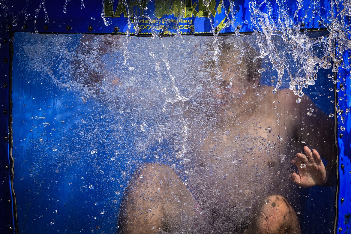 Aiden Krause splashes into the dunk tank at the Knights of Columbus Brisket Showdown at the Flathead County Fairgrounds on Saturday, July 30. (Casey Kreider/Daily Inter Lake)