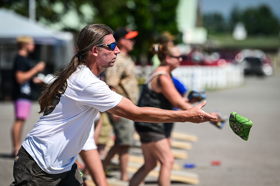 Mike Strickland with the team Grateful Bags, tosses in the cornhole tournament at the Knights of Columbus Brisket Showdown at the Flathead County Fairgrounds on Saturday, July 30. (Casey Kreider/Daily Inter Lake)